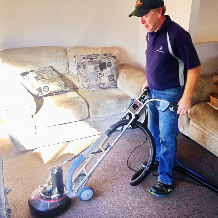 Owner working on a carpet with Rotovac Industrial Cleaner